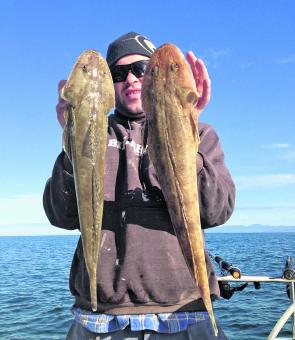 Danny shows off this pair of big flathead caught offshore near the islands. Winter is the time for big offshore flathead.