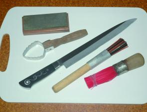 An IO Shen Sashimi knife, gut brushes, a scaler, a sharpening stone, and a cutting board, are all you need for cleaning your catch once you are back on dry land.