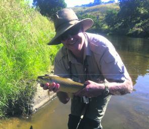 Jim Bambridge with a nigh on 1kg brown trout caught in a local Ballarat stream on a flashback nymph. Photo courtesy Bruce Pipcorn.