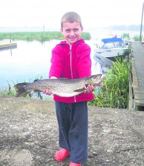 Hughie McKenzie of Mornington with a brown trout caught while fishing with his grandfather Terry Reilly. This fish was caught in about a metre of water using a mudeye bait.