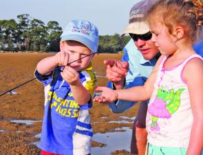 Take the time to let your kids try rigging their own lines. Calissa holds the terminal tackle while brother Clay runs the line through the guides.