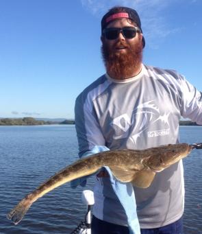 Chris (Big Red) with a great sized flathead taken from the creek mouths adjoining the passage.