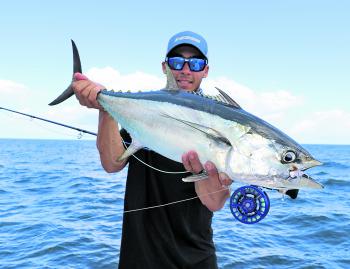 The author with a school size longtail tuna, which was fooled by a small baitfish imitation fly.