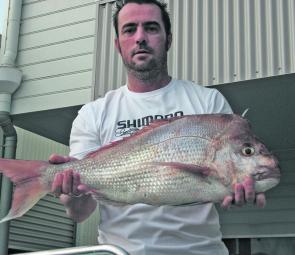 The author with 75cm of hard fighting, chrome red snapper. They are biting exceptionally well late in the afternoon on the incoming tide.