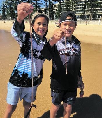 Brothers Daniel and Dylan Leupen with their first beach worms. 