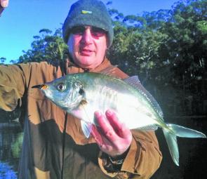 John with a hard fighting silver trevally caught on a lure.