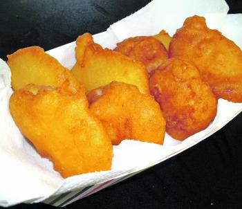 A basket of potato scallops ready for a light dusting of salt flakes. 