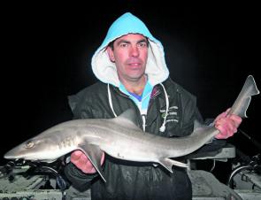 David Lockley cradles a gummy shark from Western Port while on board Big Time Charters.