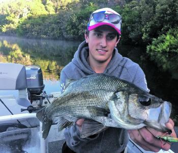 Dane Handreck with a big bucket mouth estuary perch, caught on a surface lure in the snags.