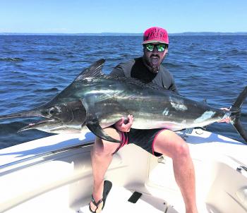 Brennan Webster with a beautiful black marlin.