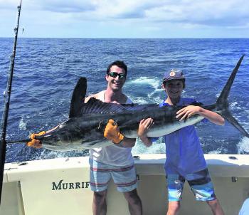 Mike Brown and Scooter Kerstens hold up more than a handful of marlin!