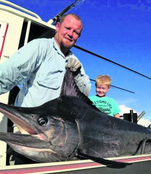 Scott Adams with his 100kg striped marlin and Harry Adams looking very pleased with daddy’s fish.