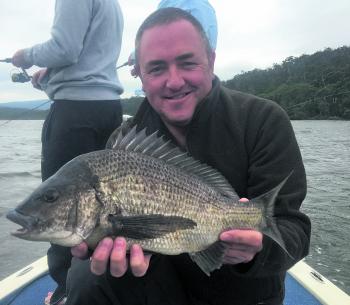 Jason Neuman with a cracking black bream caught from the shallows on a very windy day.