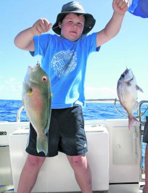 A happy customer with a tasty double hook-up – a snapper and a tuskfish.