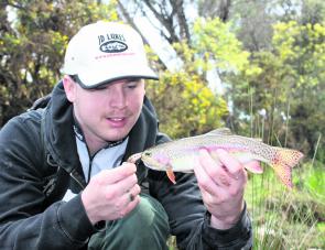 Cameron Smith with a typical sized rainbow trout from the Ovens River upstream of Bright.