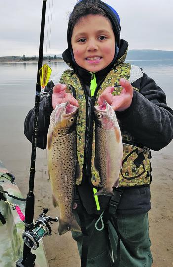 Gabriel Baker, nine years of age, with an awesome brown trout and a rainbow trout caught trolling a yellow wing Tasmanian Devil from his dad’s kayak.