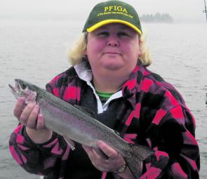 Amanda Walshaw with a healthy winter rainbow. A wet end to spring may mean a continuation of the great lake fishing.