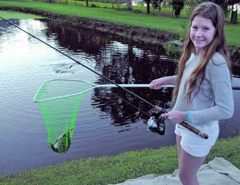 Tilapia are handy for introducing youngsters to fishing. Gabby looks very happy with her fish. 