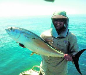 Longtail tuna are smashing up bait around Mackay Harbour, Brett Gesch proudly shows off a top fish caught casting slugs to feeding fish