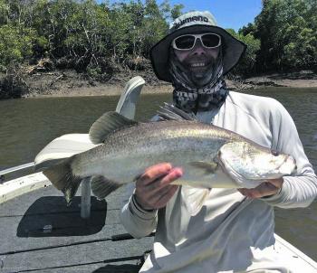 Work a lure near a gully mouth and like Luke Barnes you are likely to catch a lovely saltwater barra. Check out the gully and snag over his shoulder.