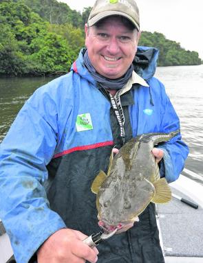 Craig Costigan with a good flathead caught in some ordinary weather.