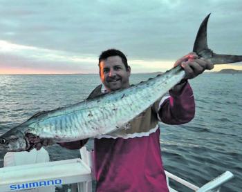 Rob See with a sunrise Spanish mackerel.