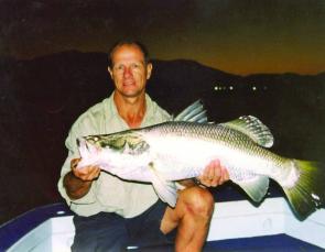 The best way to look after a barra is to keep it horizontal by supporting it mid way along with one hand and have a firm grip inside the mouth with the other. The author holds up a well conditioned Cairns barramundi that took a night time bait intended fo