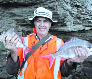 Jeff Hunt with the fruits of his labour, a couple of wash-loving snapper.