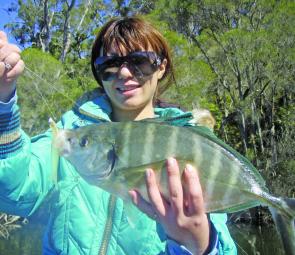 Yoki with a silver trevally that fought all the way to the boat after it ate a soft plastic lure.