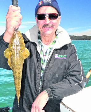 Mario with a hard-earned flathead. Sometimes the days are slow before the run-in tide.