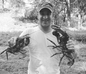 Rob Embury shows off two Gippsland freshwater spiny crayfish, which were released back into the Tarago River.