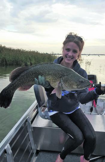 Daneka Robinson with an 80cm cod she caught off the surface.