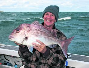 ‘Ace angler’ Steve McEwan with a winter snapper caught under trying conditions. This June weekend will hopefully be wind-free and produce some no pressure snapper fishing.