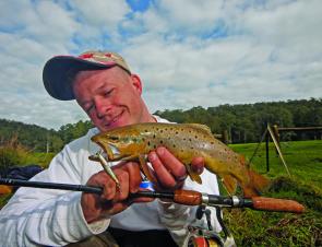 The author displays a stream trout caught on a Yo-Zuri 50mm Pins Minnow.