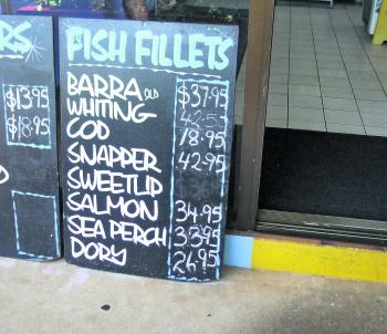 This photo on the left shows the price of local whiting and barra at $37.95 and $42.50/kg respectively. By comparison the photo on the right shows red spot emperor and sweet lip fillets imported from Indonesia at a reduced cost – $26.99 and $28.99 re