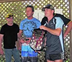 From left, the ABA’s Chris Estreich presents the teams shield to Rob Gaden and Brian Macfarlane.