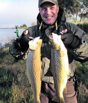 Anthony McGrath seems pretty pleased with his haul of brown trout at Hepburn Lagoon. He caught the pair on wood and bardi grubs (photo courtesy of Simon Antonello)
