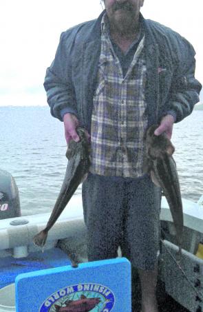Graham Kerkow with two cracker flathead caught in the Pumicestone Passage.