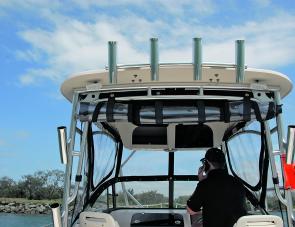 There are a lot of useful hand holds associated with the Grady White’s big hard top; check out those rod holders. 