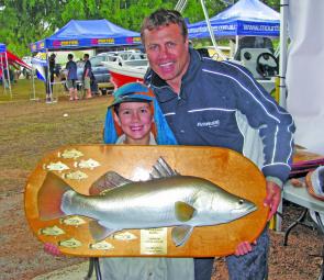 Champion junior angler Nicholas Thinee proudly shows off his trophy with special guest ET.