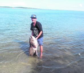 Dane with a monster gold spot cod that took the interest of the sharks.