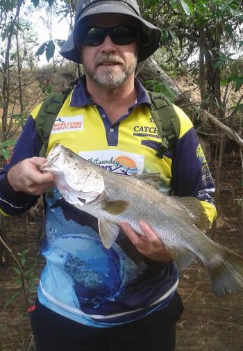 The author with an LNP barramundi caught and released while walking the riverbanks. 