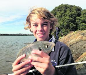 Jarred looks happy with his silver trevally he caught in the Barwon River.