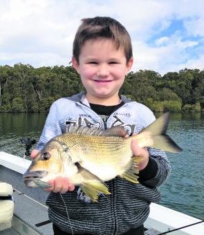 Using the right bait or lure is a key to turning a slow bite around. Six-year-old Noah Ellis-Helmers proudly shows off his 34cm bream.