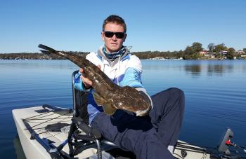 Kayak angler Bryce Oliver with a Lake Mac flatty that took a liking to his Bait Breath soft plastic. 