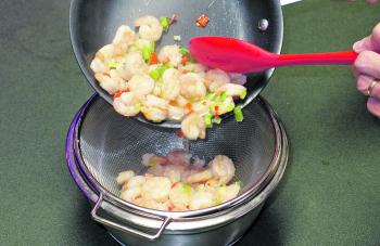 Transfer the contents of the pan to a bowl and stir through the lime juice. Then drain the contents of the bowl through a sieve to remove any liquid. Doing this will minimize the risk of a soggy quesadilla.