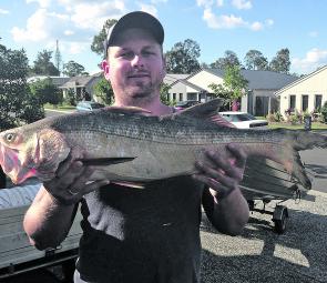 Cody lynch with a decent Logan River king threadfin salmon on a banana prawn.