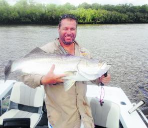 Tony Doggen proudly holds his first barra over a meter.