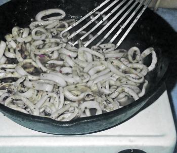 Heat the olive oil in a heavy based frypan (cast iron is a good choice). Add the calamari rings to the pan and sauté for a couple of minutes. Remove the pan from the heat. Spoon the cooked calamari rings onto some paper towels to drain while you assemble 