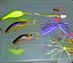 At left, from top, three great Aussie-made trolling minnows that get down around 5m to 6m: Stuckey, Viking Talisman, Halco Poltergeist. At right, bladed lures for fishing the weed and thick timber: from top, Berkley 3” Hollowbelly Split Tail on 1/4oz Nitr